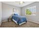 Serene bedroom with a full bed, carpet, and a large window, creating a relaxing and inviting space at 418 Hayloft Way, Brighton, CO 80601