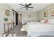 Comfortable bedroom with a ceiling fan, stylish decor, and an open doorway at 418 Hayloft Way, Brighton, CO 80601