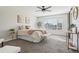 Inviting bedroom with plush carpet, shiplap accent wall, and a comfortable bed at 418 Hayloft Way, Brighton, CO 80601