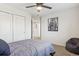 Casual bedroom featuring a full bed, carpet, a ceiling fan, and a view of the closet and hallway at 418 Hayloft Way, Brighton, CO 80601
