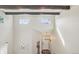 Spacious entryway with high ceilings, wooden beams, and a modern chandelier, creating a grand entrance at 418 Hayloft Way, Brighton, CO 80601