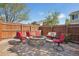 Outdoor firepit with stone surround and seating, perfect for entertaining in fenced backyard at 418 Hayloft Way, Brighton, CO 80601