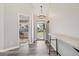 Bright and airy foyer with wood-look tile flooring, a console table, and an open view into adjacent living spaces at 418 Hayloft Way, Brighton, CO 80601