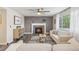 Inviting living room featuring a cozy fireplace, modern furnishings, and natural light from a large window at 418 Hayloft Way, Brighton, CO 80601