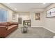 Comfortable living room with plush leather sofa, stylish decor, and well-lit with a window at 418 Hayloft Way, Brighton, CO 80601