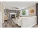 Cozy living room with a fireplace, neutral color palette, wood-look flooring, and abundant natural light at 418 Hayloft Way, Brighton, CO 80601