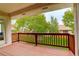 Covered back deck with wood railings, perfect for outdoor relaxation and enjoying the landscaped backyard at 160 Las Lunas St, Castle Rock, CO 80104