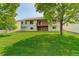 Well-maintained backyard with a manicured lawn, patio area, and mature trees, offering serene outdoor living at 160 Las Lunas St, Castle Rock, CO 80104