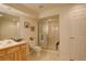 Clean bathroom featuring a glass-enclosed shower, toilet, and wooden vanity at 160 Las Lunas St, Castle Rock, CO 80104