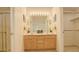 Bright bathroom with a double sink vanity, large mirror, and walk-in closet at 160 Las Lunas St, Castle Rock, CO 80104