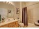 Well-lit bathroom with a vanity, mirror, tub, and shower featuring neutral tones for a clean and relaxing space at 160 Las Lunas St, Castle Rock, CO 80104