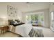Bright bedroom featuring large windows, a cozy sitting area, and elegant furnishings at 160 Las Lunas St, Castle Rock, CO 80104