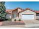 Charming home featuring a terracotta roof, manicured landscaping, and an attached two-car garage at 160 Las Lunas St, Castle Rock, CO 80104