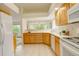 Spacious kitchen with natural wood cabinets, white appliances, and an adjacent living area at 160 Las Lunas St, Castle Rock, CO 80104