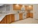 Bright kitchen features wood cabinets, white appliances, and tile flooring, providing a functional and stylish cooking space at 160 Las Lunas St, Castle Rock, CO 80104