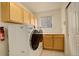 Well-equipped laundry room features modern washer and dryer, storage cabinets, and a countertop for folding at 160 Las Lunas St, Castle Rock, CO 80104