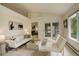 Spacious living room with modern decor, light-colored furniture, and sliding glass doors leading to outdoor space at 160 Las Lunas St, Castle Rock, CO 80104