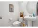 Cozy powder room features a pedestal sink and decorative wall art at 239 S Old Hammer St, Aurora, CO 80018