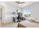 Bright bedroom featuring a desk setup, a comfortable bed, and a ceiling fan at 239 S Old Hammer St, Aurora, CO 80018