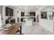 Open kitchen featuring dark cabinets, granite countertops, stainless steel appliances and a center island at 239 S Old Hammer St, Aurora, CO 80018