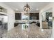 Granite island with dark cabinets, modern appliances and ample counter space for meal preparation at 239 S Old Hammer St, Aurora, CO 80018