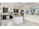 Kitchen featuring dark cabinets, granite countertops, a center island, and stainless steel appliances at 239 S Old Hammer St, Aurora, CO 80018