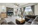 Bright living room boasts stylish decor, a ceiling fan, and large windows at 239 S Old Hammer St, Aurora, CO 80018