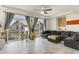 Spacious living room with tile flooring, large windows, and a comfortable sectional sofa at 239 S Old Hammer St, Aurora, CO 80018