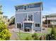 Blue three-story house with sliding glass door, patio, fenced yard and manicured lawn at 239 S Old Hammer St, Aurora, CO 80018
