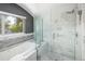 Elegant bathroom with a soaking tub, glass shower, and bright sunlight from the window at 505 Detroit St, Denver, CO 80206