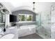 Well lit bath with double vanity, soaking tub, and marble surround with a glass shower at 505 Detroit St, Denver, CO 80206