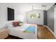 Bright bedroom with white walls, hardwood floors, and colorful pillows adds a homey touch at 505 Detroit St, Denver, CO 80206