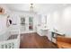 Charming Bedroom boasts hardwood floors, a crib, a changing table, and a walkout to the back yard at 505 Detroit St, Denver, CO 80206