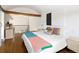 Stylishly staged bedroom with hardwood floors, bright walls, and colorful pillows at 505 Detroit St, Denver, CO 80206