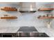 Bright kitchen featuring stainless steel appliances, open shelving, and marble countertops at 505 Detroit St, Denver, CO 80206