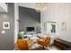 Stylish living room with a gray accent brick wall, hardwood floors, modern furniture, and large window at 505 Detroit St, Denver, CO 80206