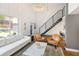 Open concept living room with hardwood floors, modern lighting, and staircase leading to the second floor at 505 Detroit St, Denver, CO 80206