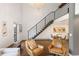 Living room with tall ceilings, modern staircase, and hardwood floors; open to the dining and kitchen areas at 505 Detroit St, Denver, CO 80206