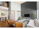 Spacious living room featuring high ceilings, modern chandelier, wood floors, and modern furniture at 505 Detroit St, Denver, CO 80206