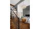 Open-concept living room showcasing a staircase, balcony, and stylish decor at 505 Detroit St, Denver, CO 80206