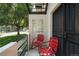 Cozy front patio with red chairs and a decorative glass block window at 505 Detroit St, Denver, CO 80206