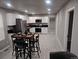 Bright kitchen featuring stainless steel appliances, white cabinetry and modern table set at 4673 Sherman St, Denver, CO 80216