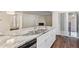 Granite island with stainless steel double sink and dishwasher in renovated kitchen with new cabinets and countertops at 9427 W 89Th Cir, Broomfield, CO 80021