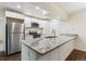Bright kitchen features stainless steel appliances, white cabinetry, and granite countertops at 9427 W 89Th Cir, Broomfield, CO 80021