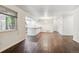 Open-concept living space with hardwood floors, natural light, and a seamless flow into the kitchen area at 9427 W 89Th Cir, Broomfield, CO 80021