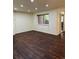 A living room with wood floors and a view of the outside through a window at 9427 W 89Th Cir, Broomfield, CO 80021