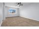 Well-lit bedroom featuring carpet, a ceiling fan and a window at 12525 E Tennessee Cir # E, Aurora, CO 80012