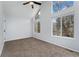 Bright bedroom with carpet flooring, ceiling fan, and large windows at 12525 E Tennessee Cir # E, Aurora, CO 80012