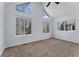 Large bedroom with vaulted ceilings and multiple windows at 12525 E Tennessee Cir # E, Aurora, CO 80012