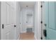 Bright hallway with light blue door and view of updated bathroom at 12525 E Tennessee Cir # E, Aurora, CO 80012